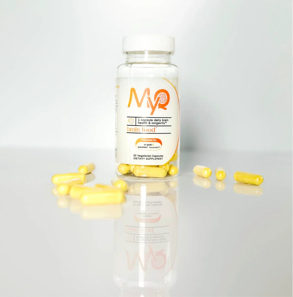 Bottle of yellow brain health dietary supplement capsules on white background