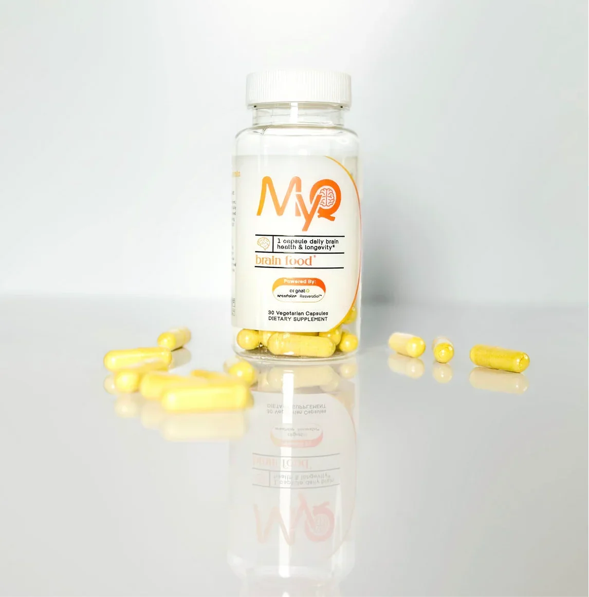 Bottle of yellow brain health dietary supplement capsules on white background