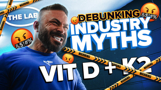Muscular man in blue shirt gritting teeth, surrounded by 'Debunking Industry Myths', 'VIT D + K2' text, angry emojis, and warning tape graphics.